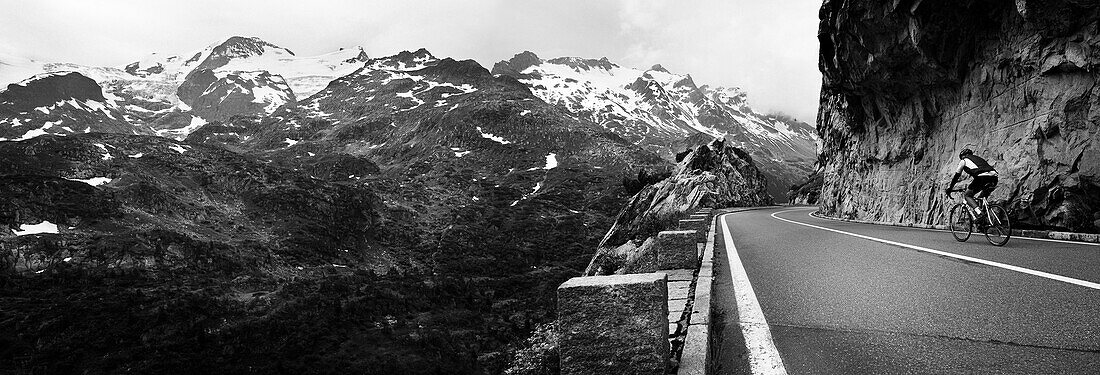 Cyclist on mountain pass, descent from Sustenpass to Innertkirchen, Bernese Oberland, Switzerland