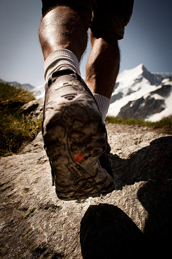 Hiker on mountain trail, on the way to Schreckhorn hut, Lower Grindelwald glacier, Bernese Oberland, Switzerland