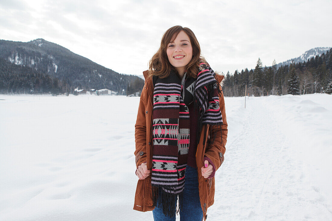 Young woman smiling at camera, Spitzingsee, Upper Bavaria, Germany