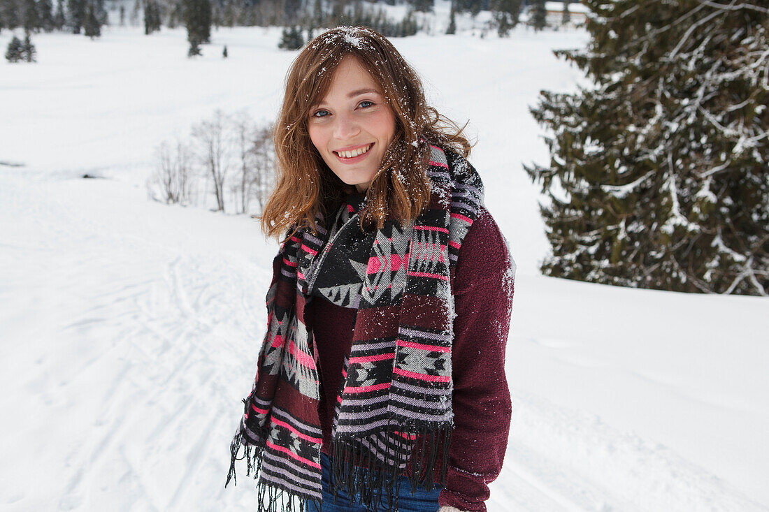 Young woman smiling at camera, Spitzingsee, Upper Bavaria, Germany