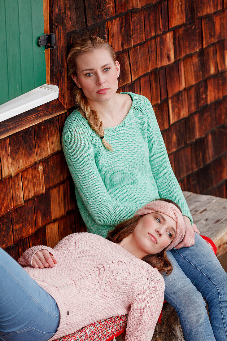 Two young women on a bench, Spitzingsee, Upper Bavaria, Germany