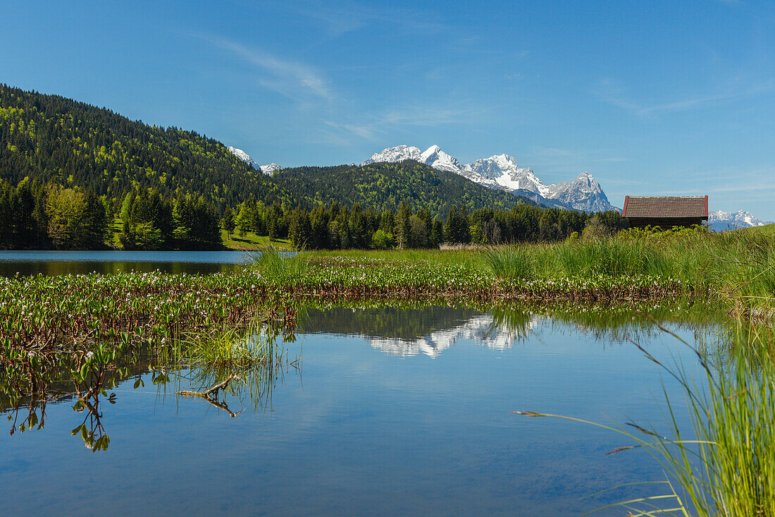 Geroldsee, lake near Mittenwald in Spring with hay barn, Wetterstein mountains, Alpspitze, Zugspitze, Waxenstein, Werdenfelser Land, Baverian Alps, Upper Baveria, Bavaria, Germany, Europe