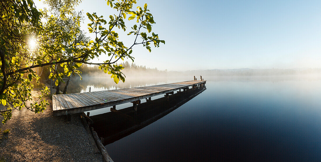 wooden pier, bathing pier at lake Kirchsee near Sachsenkamm in Spring at sunrise, moorland lake, Ellbach and Kirchseemoor nature reserve, Landkreis Bad Toelz- Wolfratshausen, Upper Bavaria, Bavaria, Germany, Europe