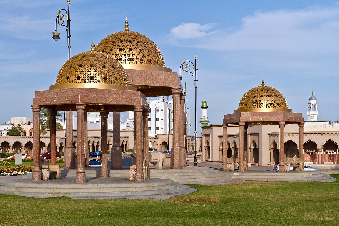 Golden domed cupolas on the harbourfront of Muscat, Oman.
