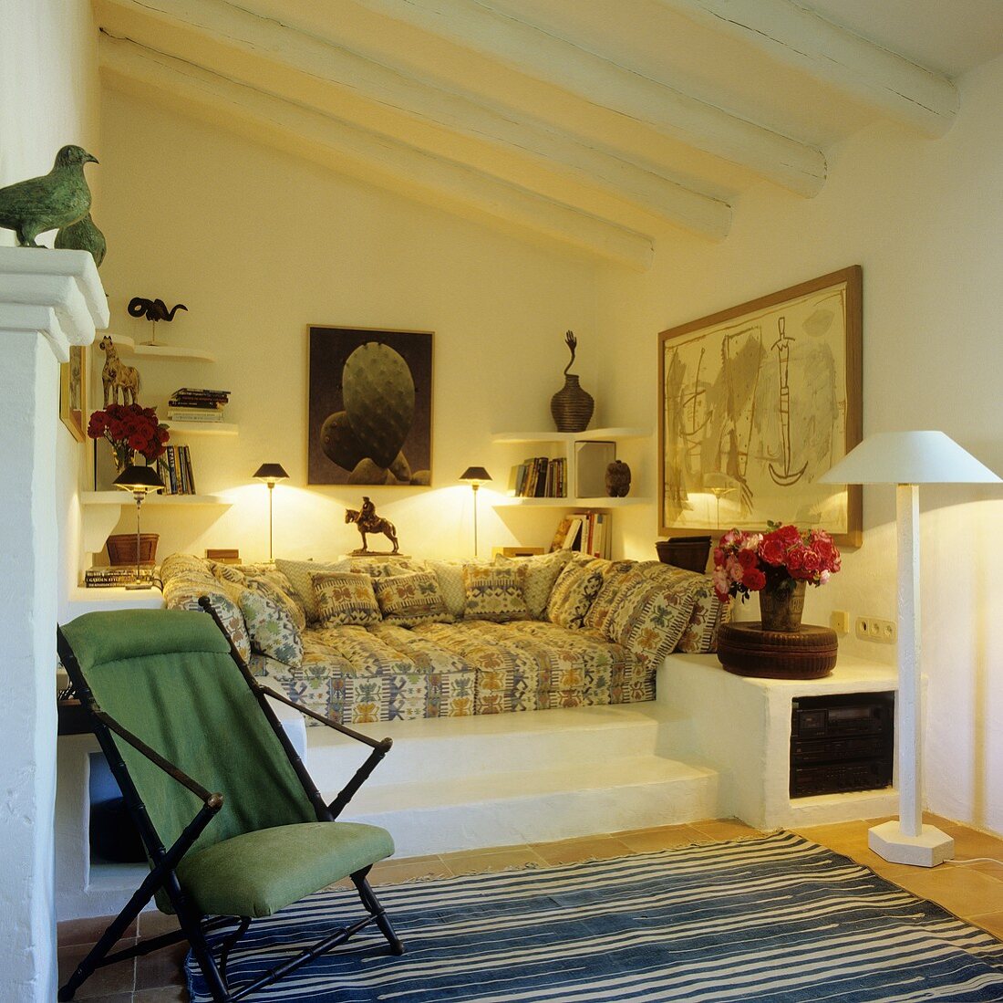 An upholstered platform in a niche with steps leading up to it in a Mediterranean country house