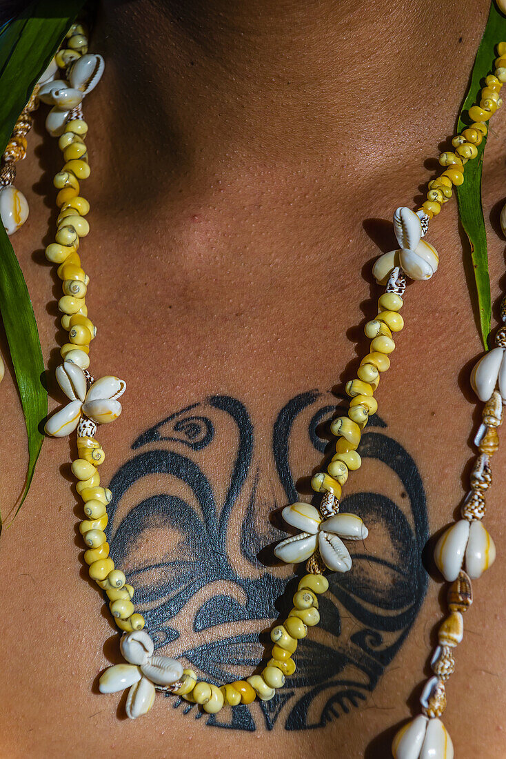 Polynesian man with tattooed chest and necklace, Four Seasons Resort Bora Bora, French Polynesia.