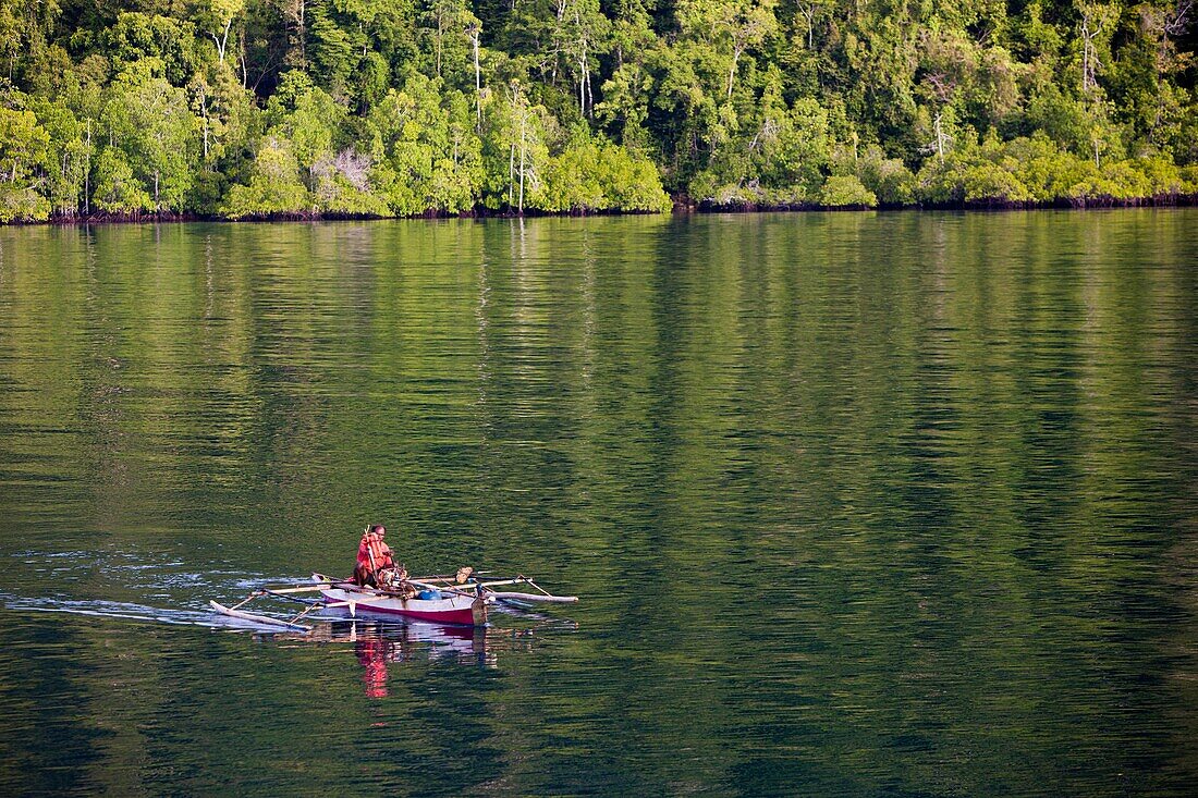 Fisherman in Outrigger, Raja Ampat, West Papua, Indonesia