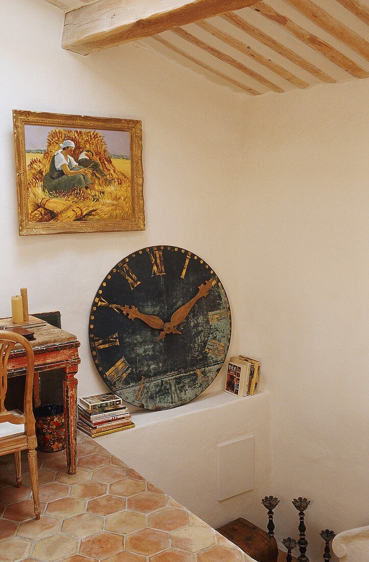 An attic in a country house - a pedestal and a shelf with an antique clock face