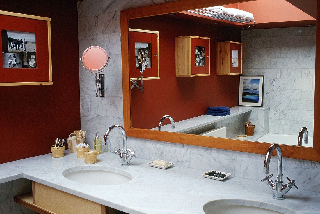 A marble-topped washstand and a framed mirror in the corner of a bathroom