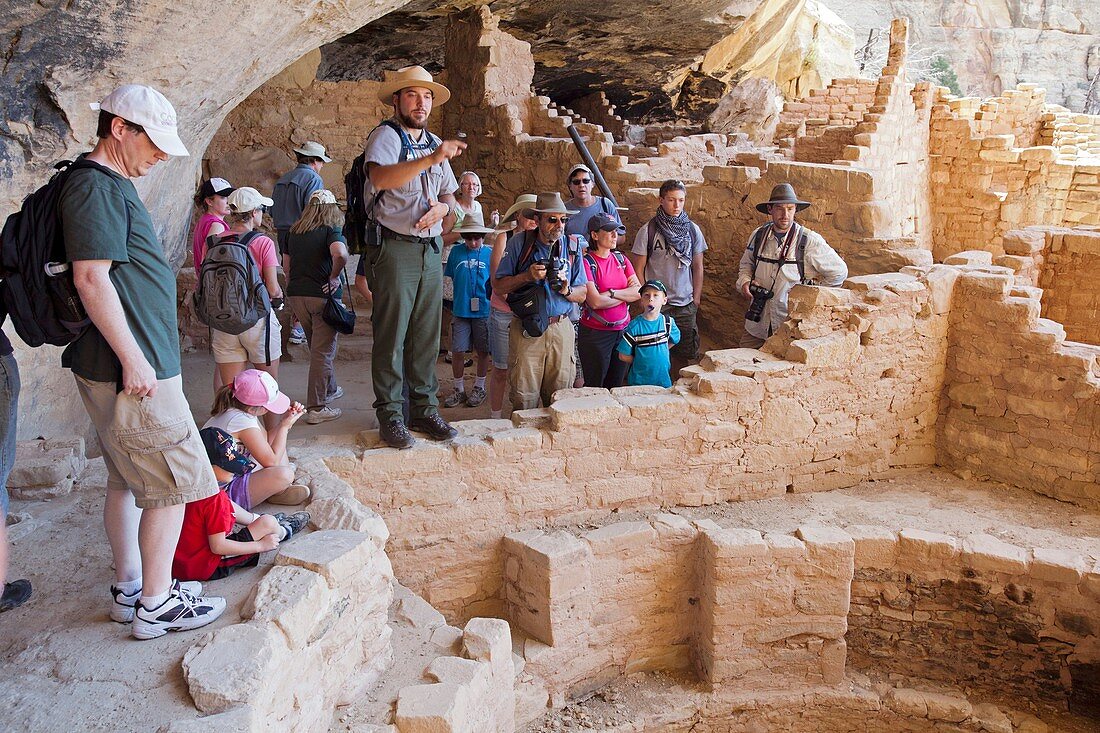 Cortez, Colorado - A park ranger talks with visitors to the Long House cliff dwelling in Mesa Verde National Park  The park features cliff dwellings of ancestral Puebloans that are nearly a thousand years old