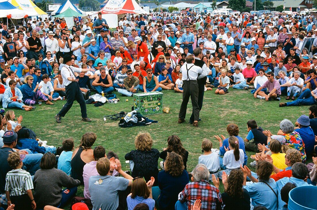 Buskers entertaining a large crowd in Hokitika, New Zealand