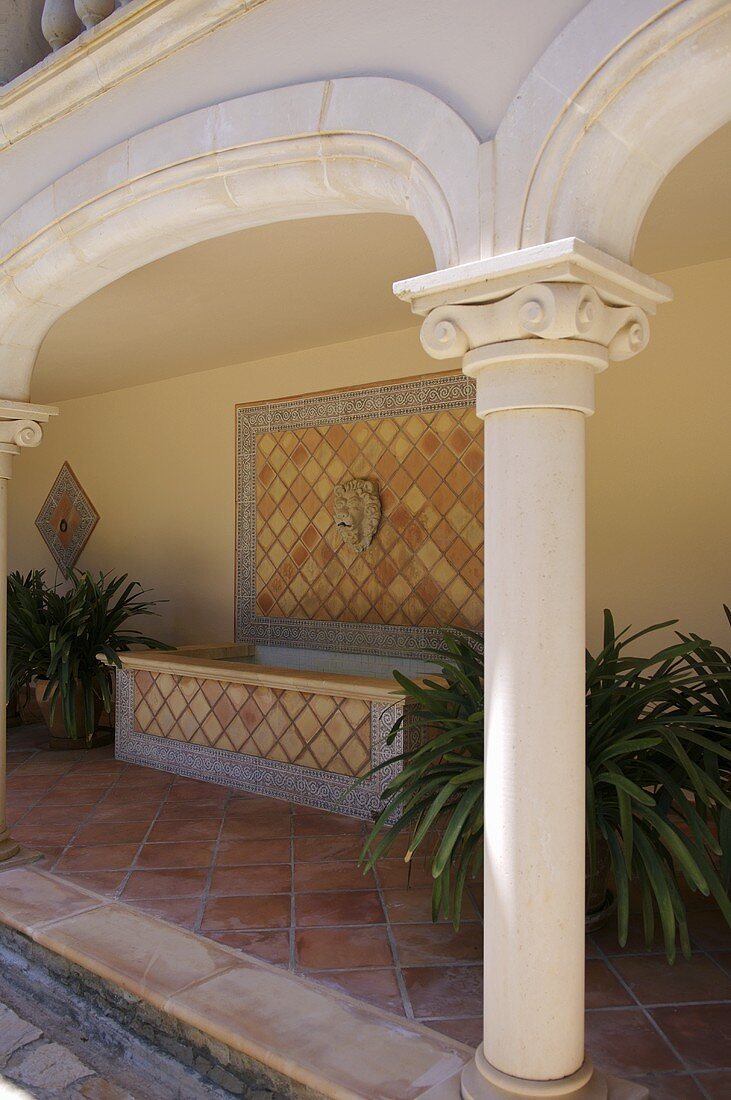 Decorative column of veranda with tiled floor and bath