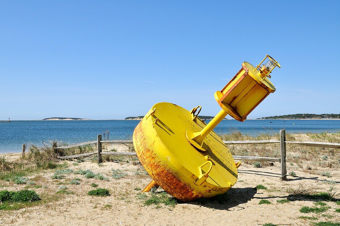 Yellow channel marker on beach at Wellfleet Harbor, Cape Cod