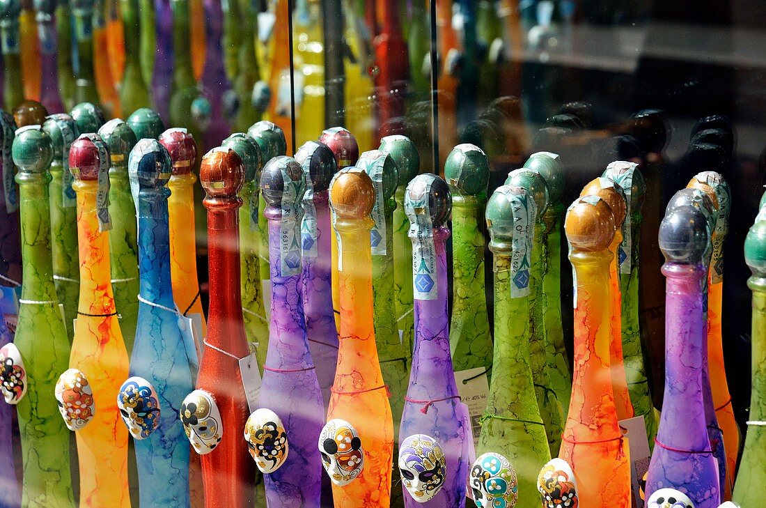 Colorful bottles of limoncello, an italian lemon liqueur, displayed at store, Venice, Italy