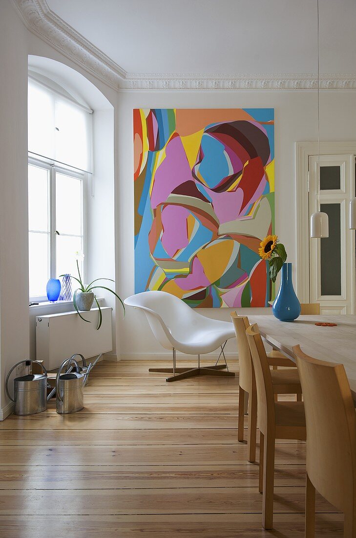 Modern dining room with Eames La Chaise in corner of room