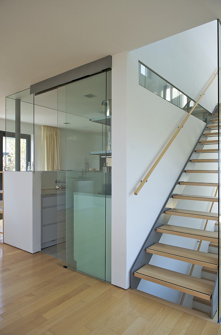 View through glass screen to modern kitchen