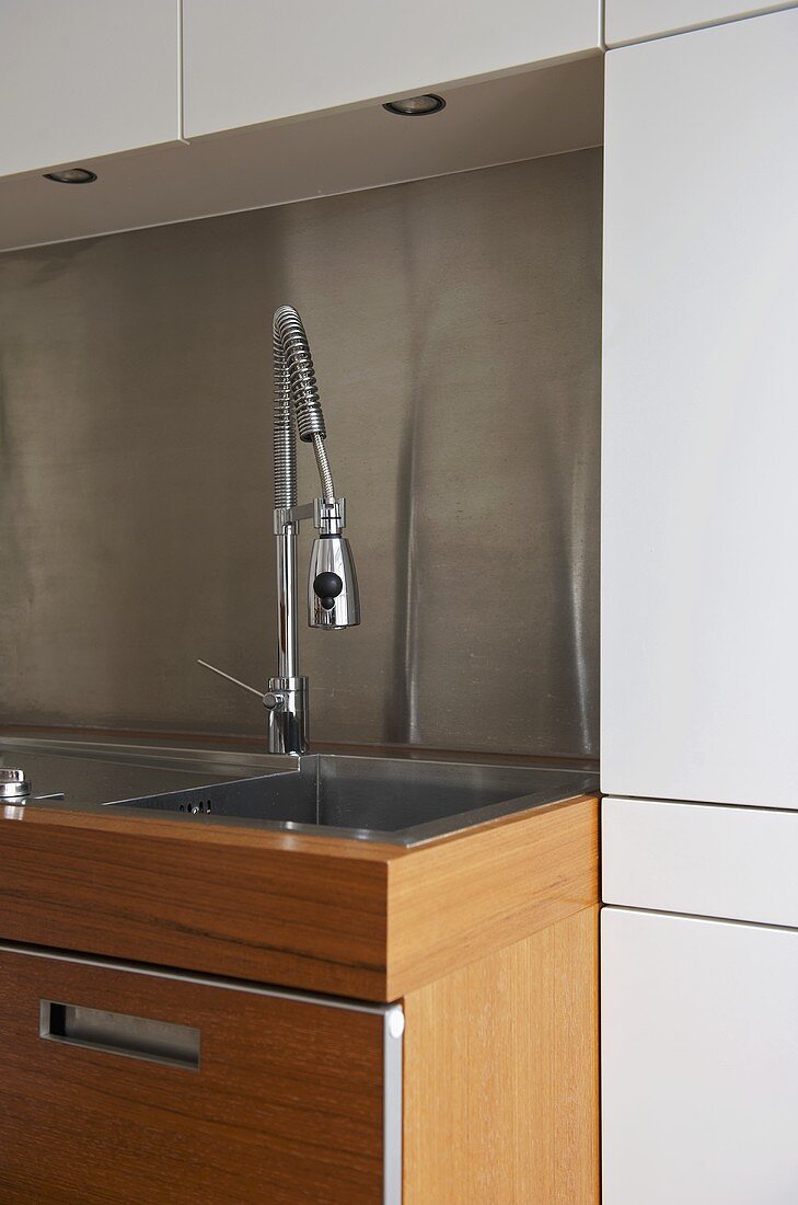 Chrome spray tap fitting over sink in modern kitchen
