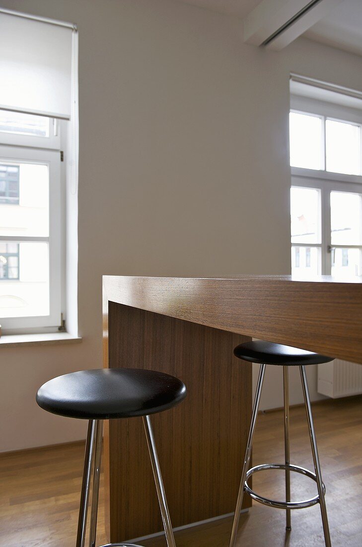 Stools with black seat at wooden breakfast bar