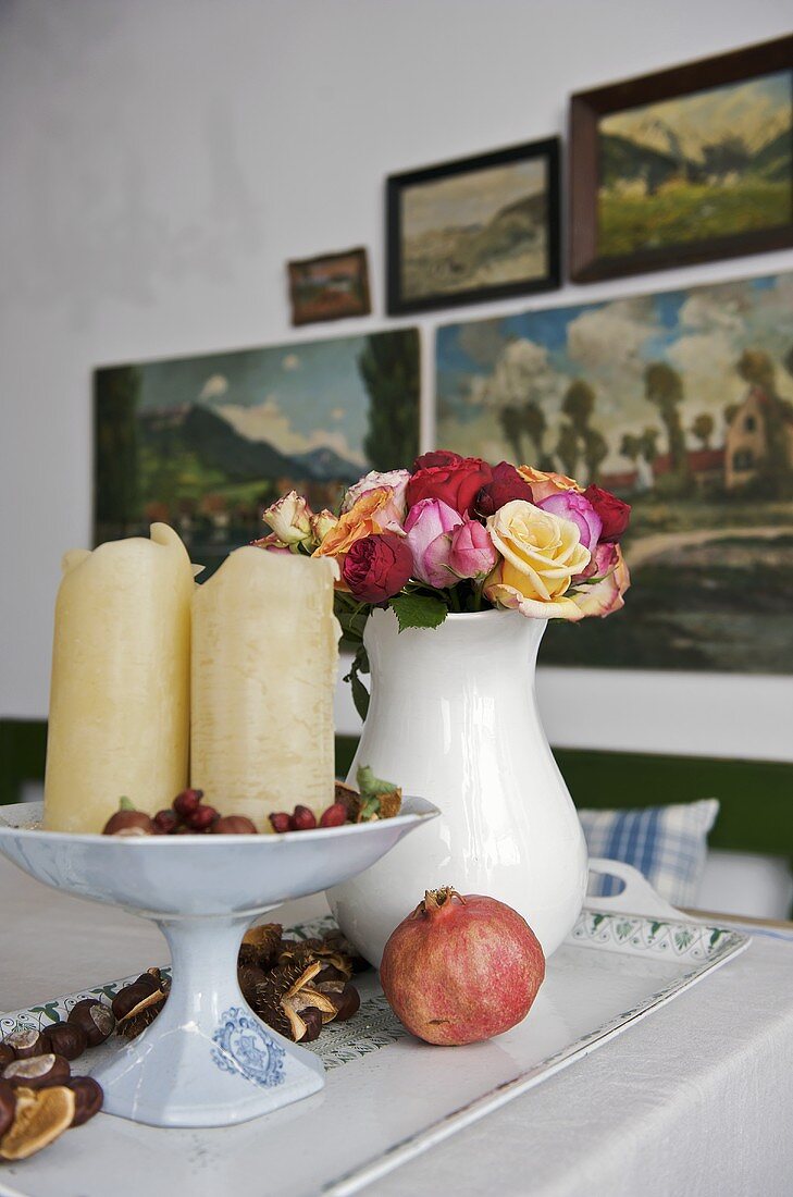 Flowers in vase and candles on dish