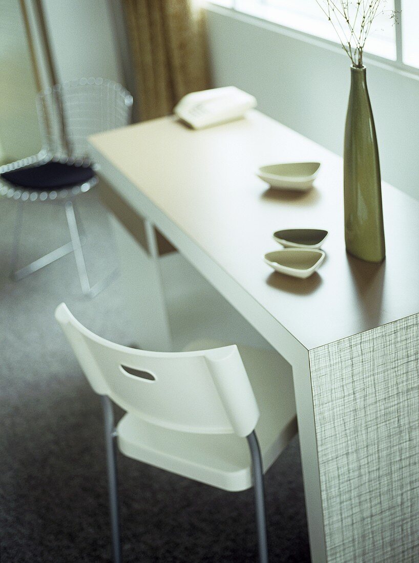 Hotel bedroom with retro styled dressing table and white plastic chair