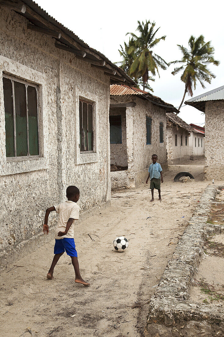 Children playing with the ball in the village, Jambiani, Zanzibar Island, Tanzania, Indian Ocean, East Africa.