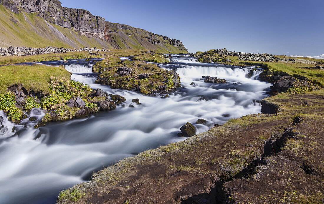 Raging river and waterfalls along Route 1 Fjaorfargigljufur Iceland
