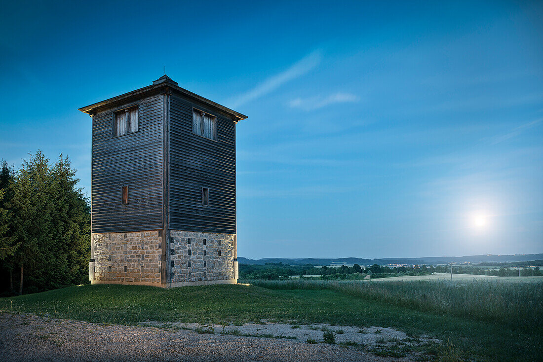 reconstruction of Roman watchtower during the moon is rising, Limes (border wall of Roman Empire) Park Rainau-Buch, Aalen, Ostalb province, Swabian Alb, Baden-Wuerttemberg, Germany, UNESCO world heritage site