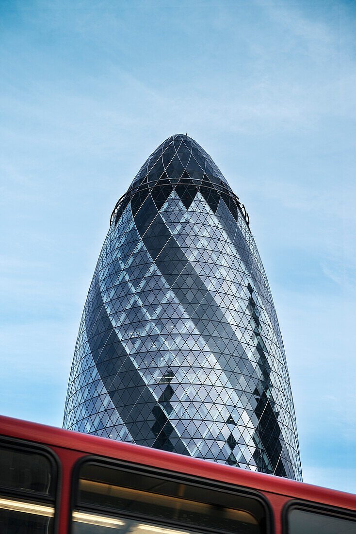 abstract view of Gherkin by Norman Foster with red London bus, Liverpool Street, City of London, England, United Kingdom, Europe