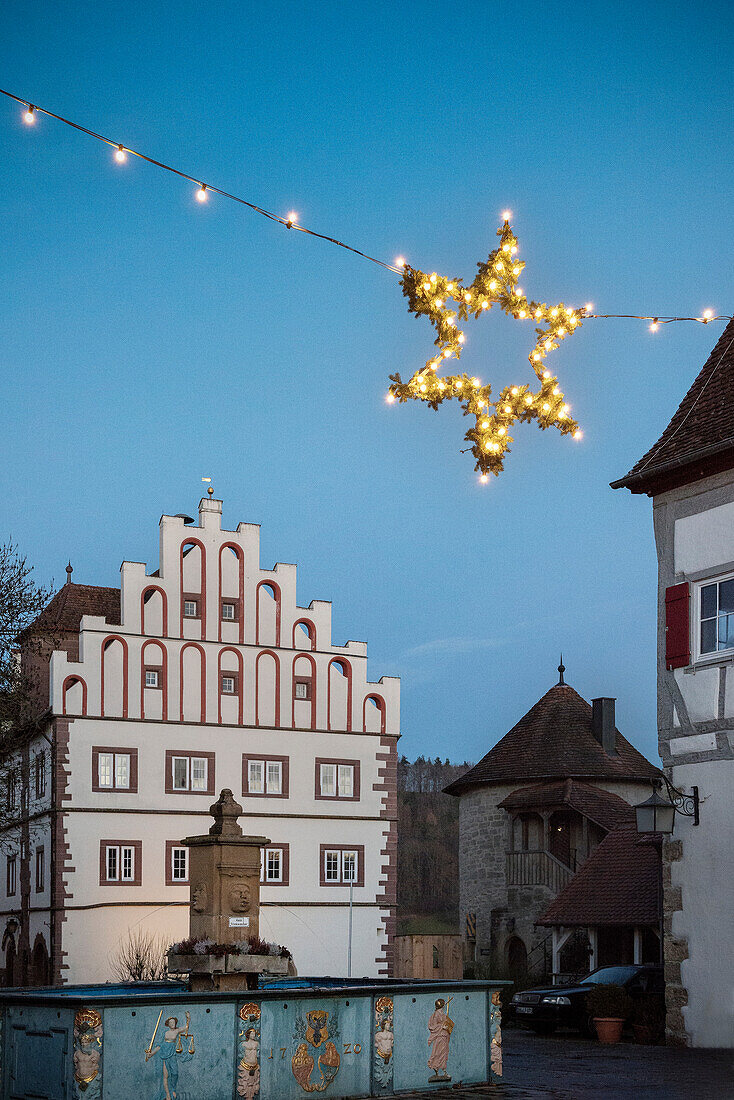 Blick auf Stadtbrunnen und Schloss mit Weihnachtsstern in Vellberg, Landkreis Schwäbisch Hall, Baden-Württemberg, Deutschland