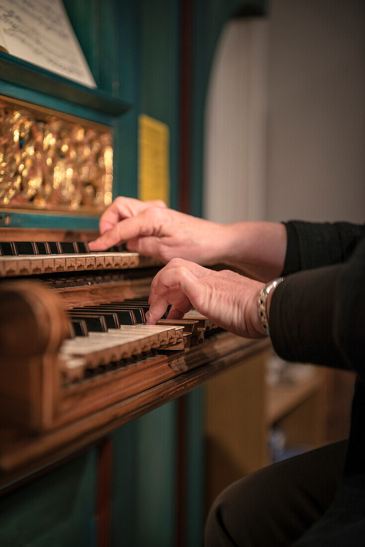 elderly woman playing the the organ in a church, Schwaebisch Hall, Baden-Wuerttemberg, Germany