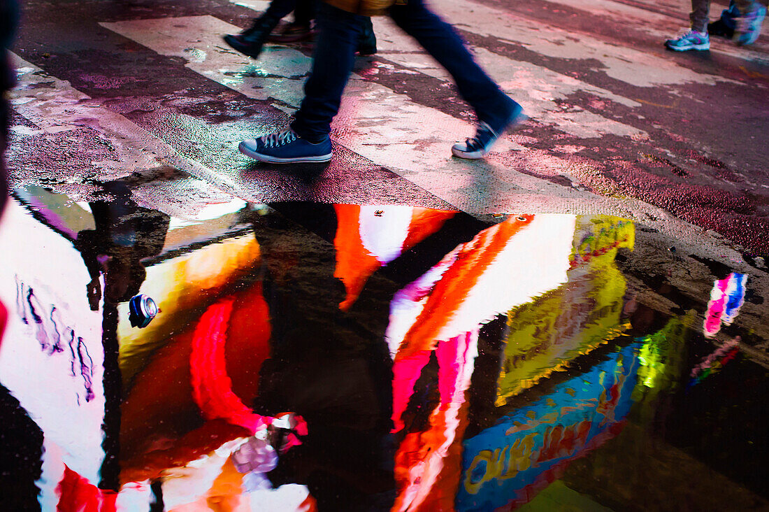 Reflection of a neon sign in a puddle, Times Square, Midtown, Manhattan, New York, USA