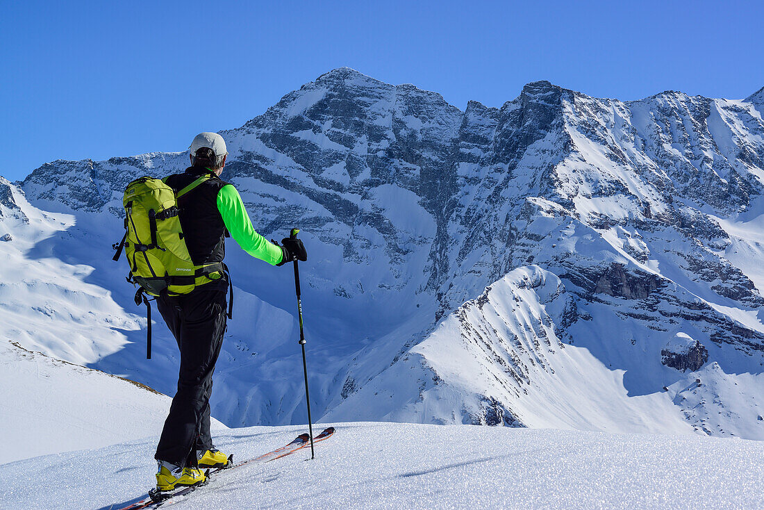 Man back-country skiing looking towards Schrammacher, Gammerspitze, valley of Schmirn, Zillertal Alps, Tyrol, Austria