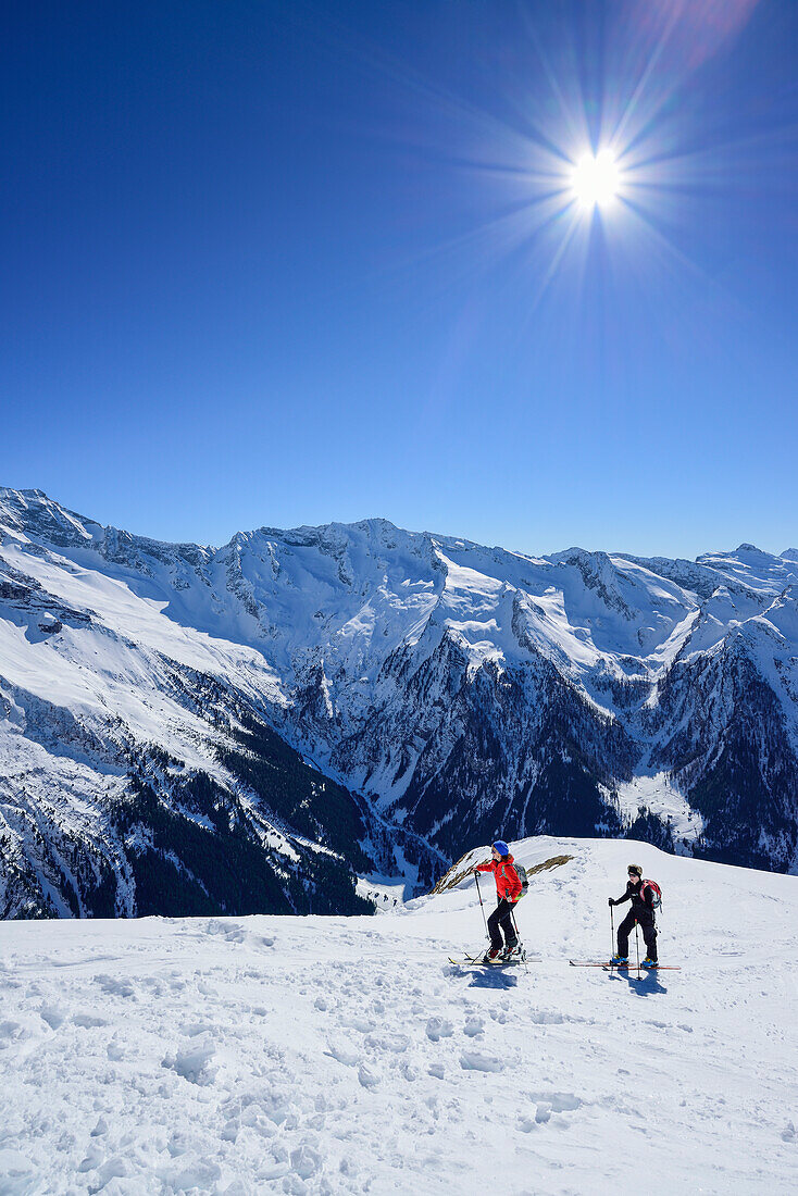 Two women back-country skiing ascending towards Gammerspitze, Zillertal Alps in the background, Gammerspitze, valley of Schmirn, Zillertal Alps, Tyrol, Austria