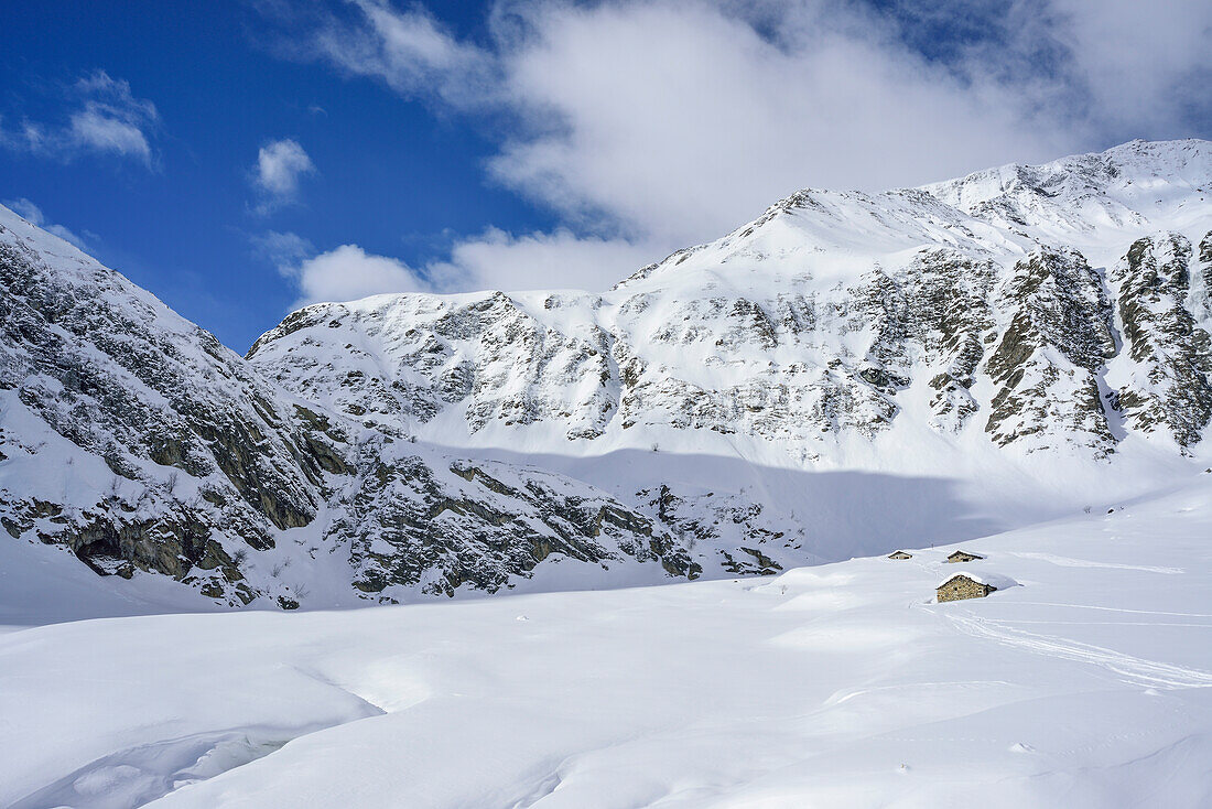 Winter landscape with snow-covered alpine huts, Monte Faraut, Valle Varaita, Cottian Alps, Piedmont, Italy