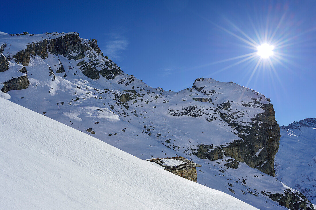 Alpine hut in front of Rocca Senghi, Monte Salza, Valle Varaita, Cottian Alps, Piedmont, Italy