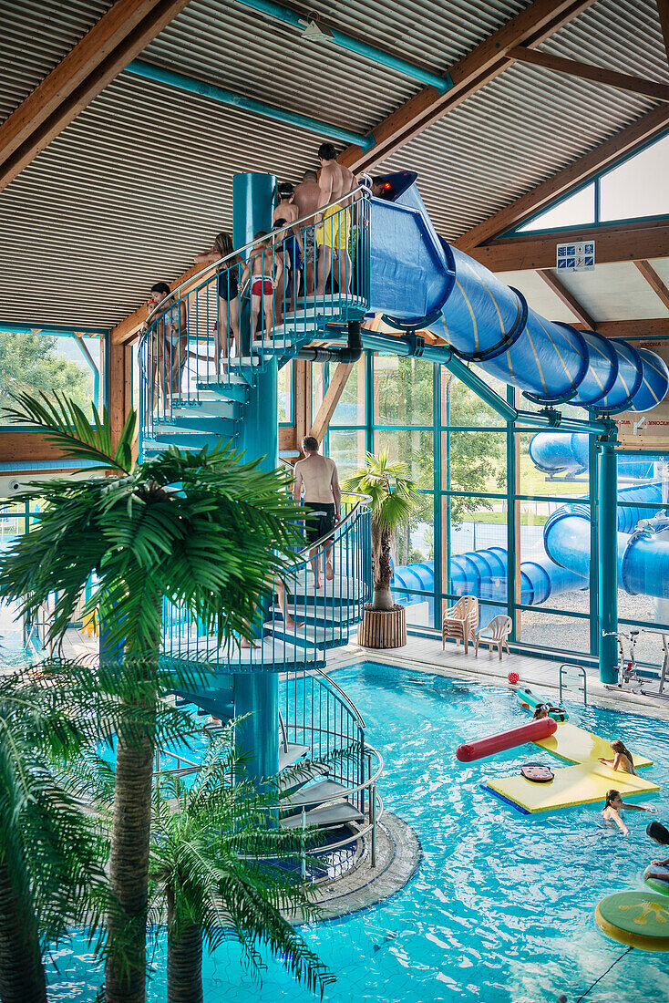 Guests in front of the water slide at the indoor swimming pool, Blaustein, Swabian Alb, Baden-Wuerttemberg, Germany