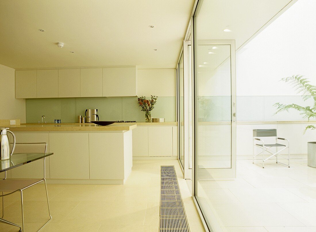 Open plan kitchen and dining area with glass doors to patio.