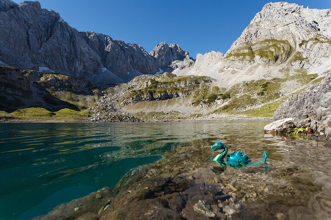 Lake Drachensee with toy dragon, vorderer Drachenkopf, mountains, near Ehrwald, district Reutte, Tyrol, Austria, Europe