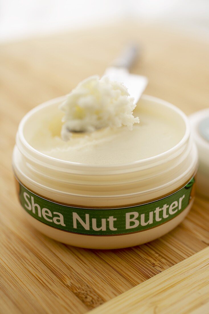 Opened Container of Shea Nut Butter with Knife, Close Up