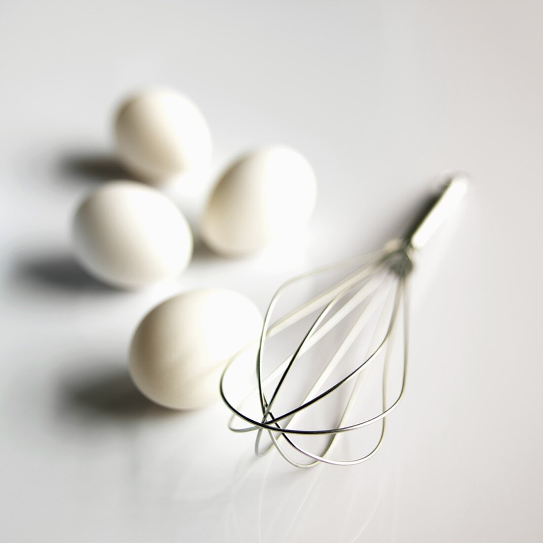 Metal Whisk with  Four White Eggs