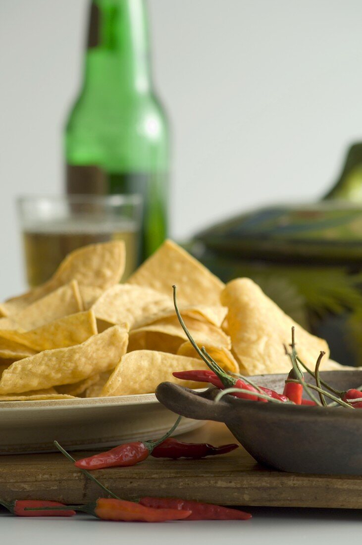 Tortilla Chips with Red Chili Peppers, Bottle and Glass of Beer