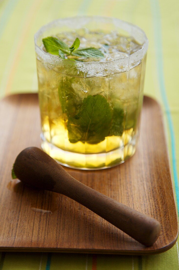Mint Julep made with Kentucky Bourbon in a Glass on a Wooden Tray
