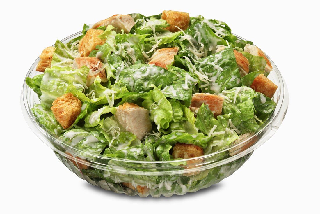 Bowl of Chicken Caesar Salad on a White Background