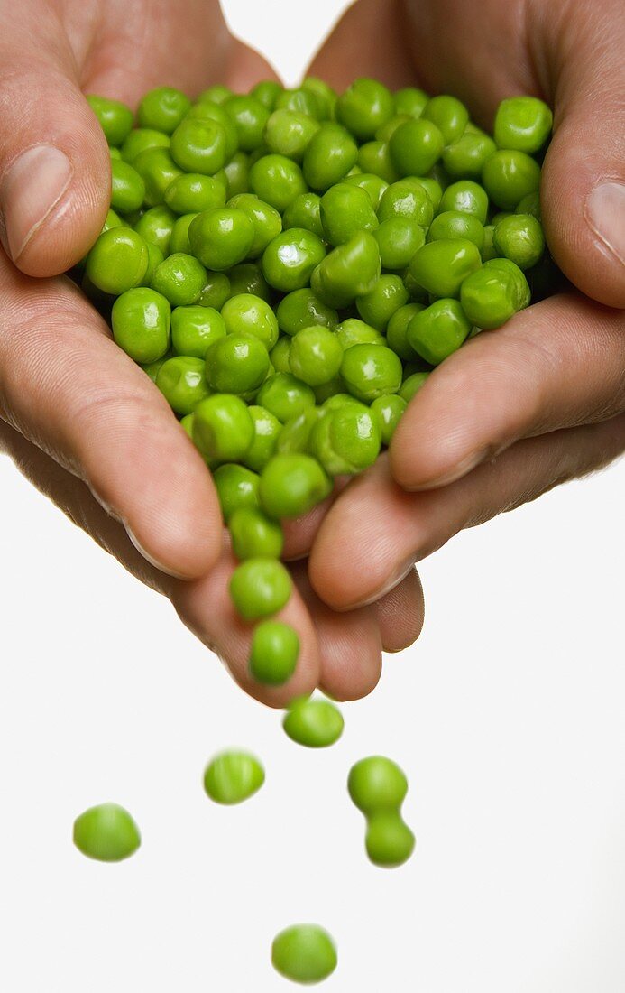 Peas Spilling From Hands