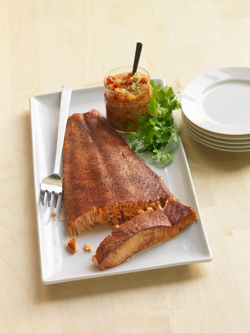 Grilled Salmon Fillet on a Platter; Stack of Serving Plates