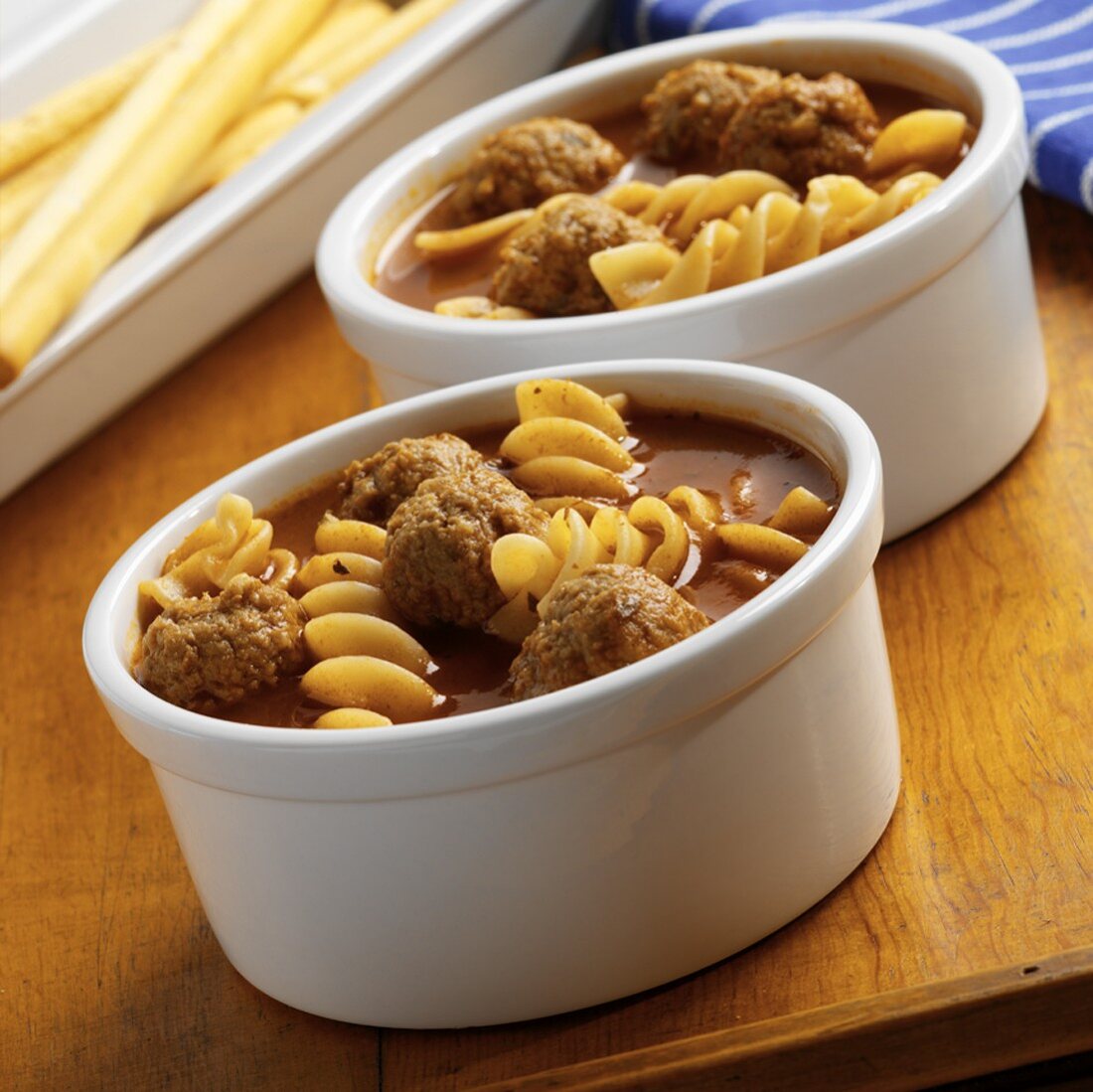 Two Bowls of Meatball Soup with Fusilli Pasta