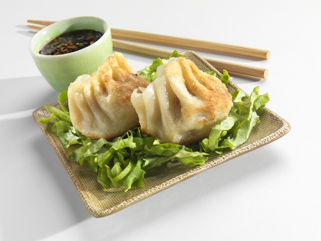 Two Potstickers with Soy Dipping Sauce and Chopsticks
