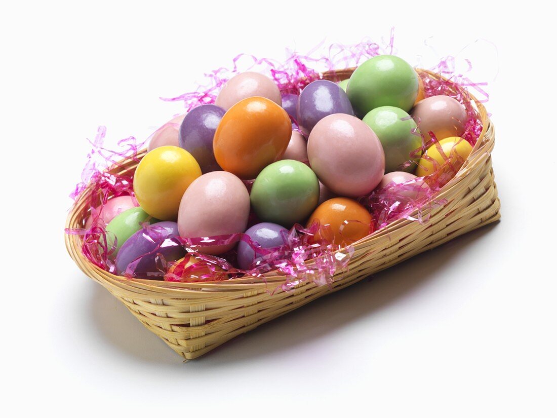 Basket of Candy Easter Eggs on a White Background