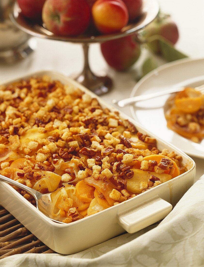 Sweet Potato and Apple Gratin in a Baking Dish with Serving Spoon