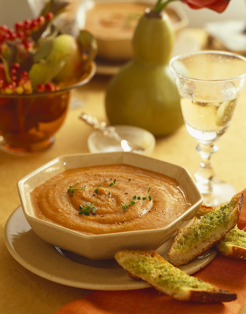 Bowl of Sweet Potato Soup with Slices of Garlic Bread, Autumn Table